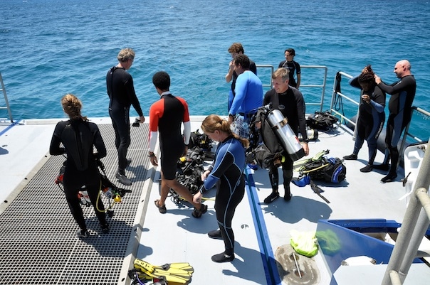 The expedition divers prepare their gear and stage it on the Shadow's stern elevator in readiness for their first practice dives.