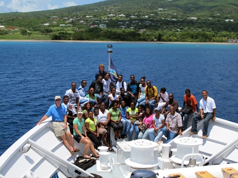 Group photo with students from St. Kitts and Nevis on the ship's bow