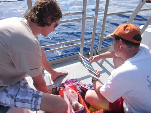 Alan Bright (left) explains coral survey equipment to Mike Trimble (right), the Navassa Mission's CREW participant.