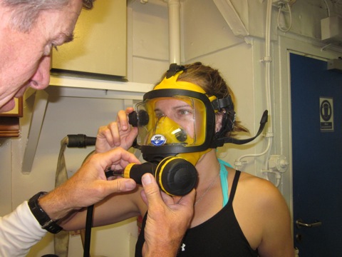 Phil Renaud helps Aurora Alifano, from Island Conservation, get a proper fit with her full-face mask.