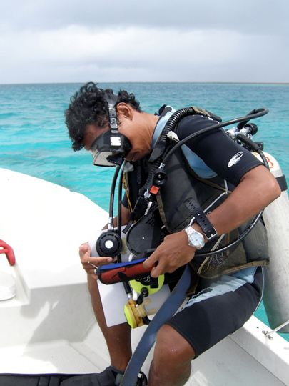 Badi Samaniego preparing for a scuba dive to survey reef fish and build on his mental fish encyclopedia.