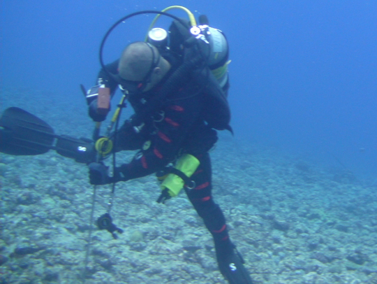 Nick Cautin, Dive Safety Officer, hammers in a stake to mark the Legacy site.