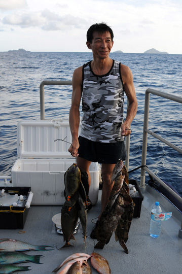 Andre Ung holds up the string of fish