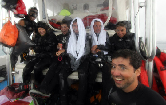 Scientific team huddle on the dive boat