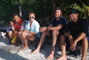 Some of the scientists from the Golden Shadow sitting with a resident of Palmerston Atoll curious about the marine park proposal.