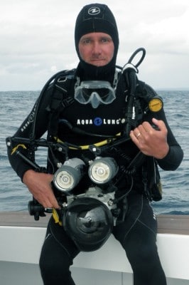 Ken Marks with his underwater camera and strobes before entering the water on a scientific dive to take a coral photo transect.