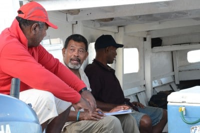 Sione Mailau taking note of the Tongan fishermen's answers to the survey.