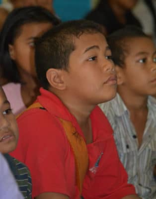 Education Research in Tonga: Students watch a video displaying coral reef scenery.