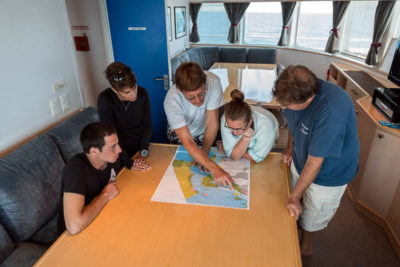KSLOF Scientists review great barrier reef zoning map aboard golden shadow.