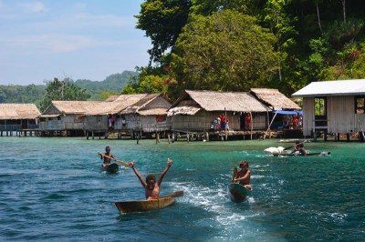 Kia Village boys canoeing after the boat.