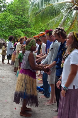 Villagers shaking hands with science and education teams. 