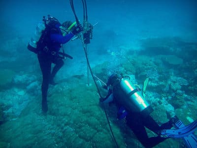 Coring at Danger Island. The coral core will be analyzed for its chemical composition in order to study climate change impacts to coral reefs at Chagos.