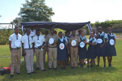 Jamaican high school students posing with organism cards for food web activity at Jamaican mangrove project