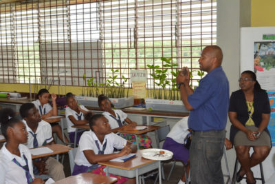 marine scientist teaching Jamaican students about sea urchins