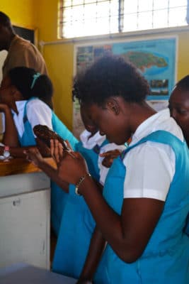 Student amazed by her first experience holding a sea cucumber.