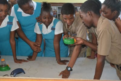 William Knibb High School students looking at a sea slug in the microviewer