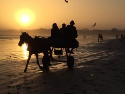 Fishermen gather on the beach at dawn to prepare for a day of fishing