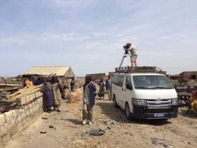 The film crew sets up in Joal to capture the day's fishing activity.