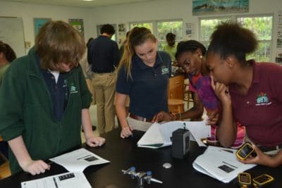 Symone Johnson helping students at Forest Heights to use a GPS device.