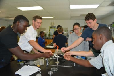 B.A.M. year 2 participants sterilizing their tweezers and scissors for the activity.