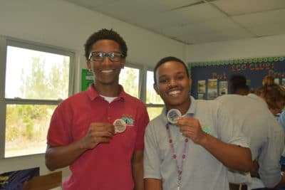 Proud students at Forest Heights hold up their "plated" diseased mangrove leaves.