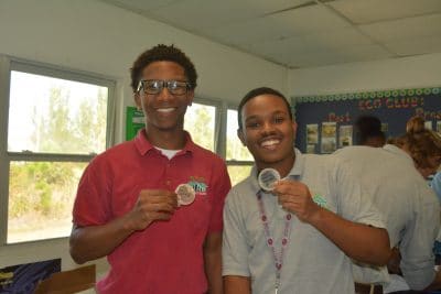 Proud students at Forest Heights Academy hold up their “plated” mangrove leaves.