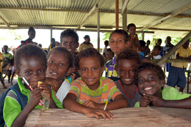 Primary students gather around at Dunde School.